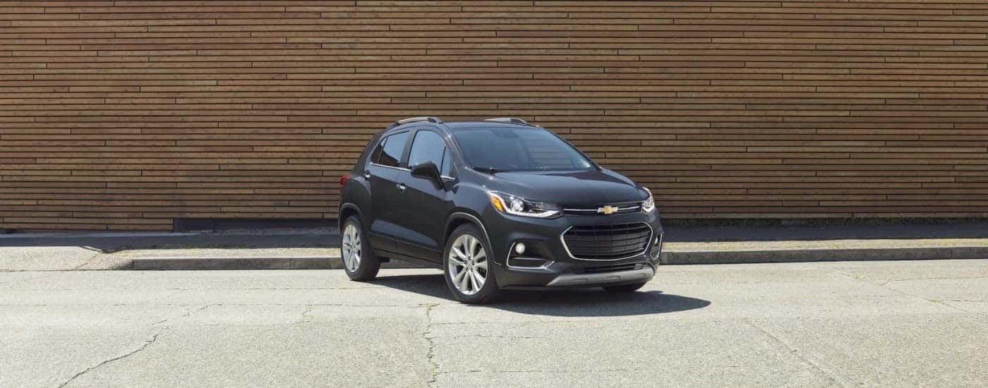 A black 2020 Chevy Trax for sale near Kannapolis parked in front of a wooden wall.