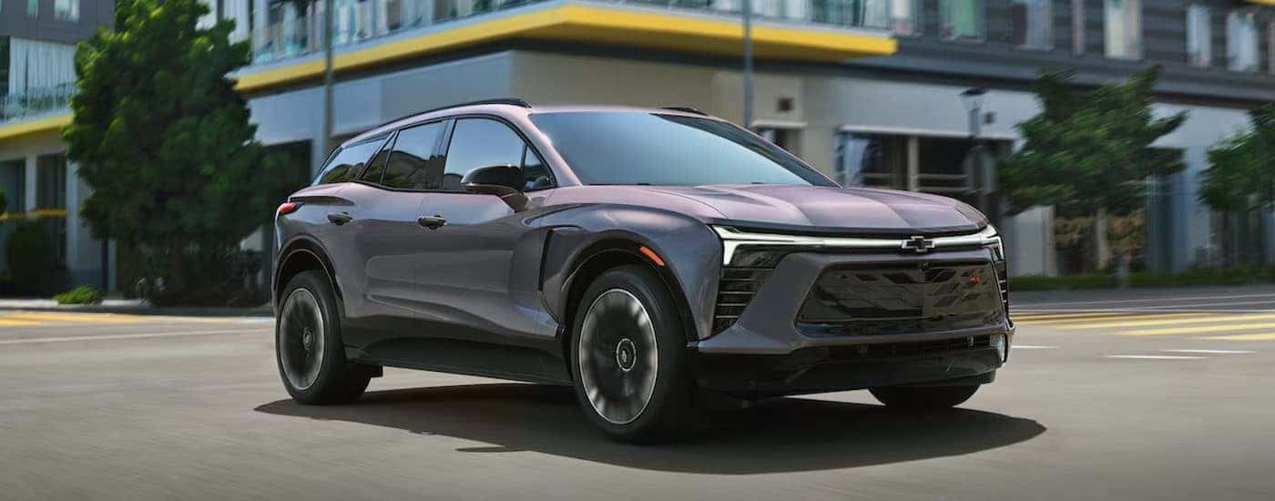 A gray 2025 Chevy Blazer EV RS driving in a city.
