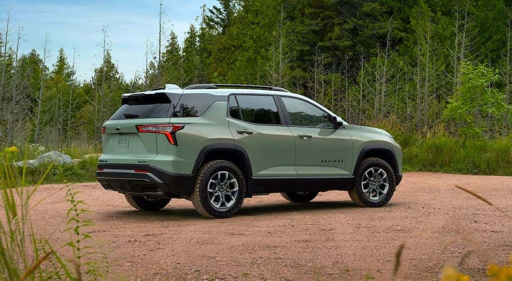 Green 2025 Chevy Equinox parked off-road.