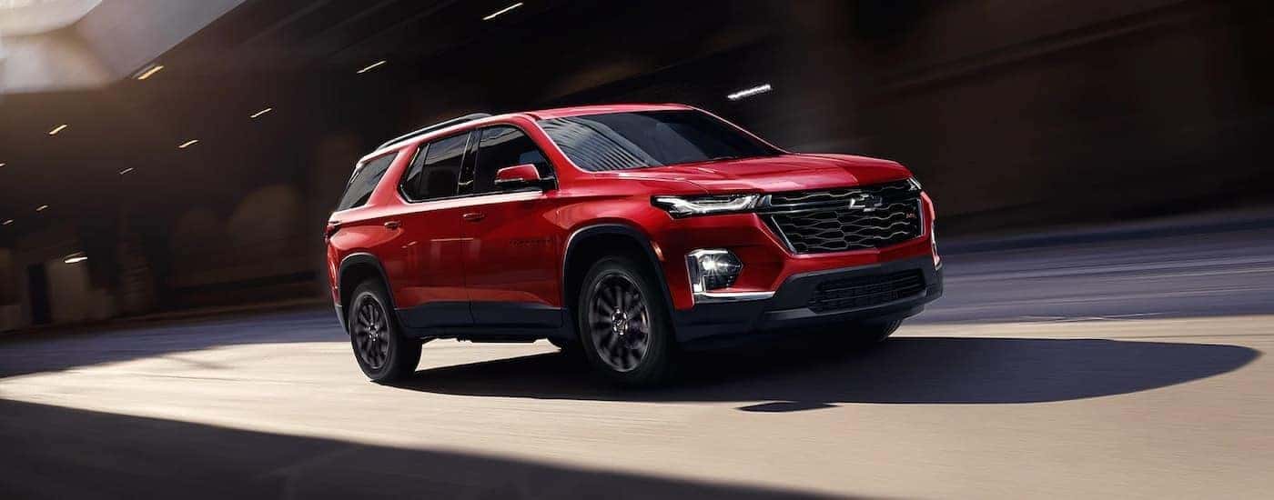 A red 2023 Chevy Traverse from the side.