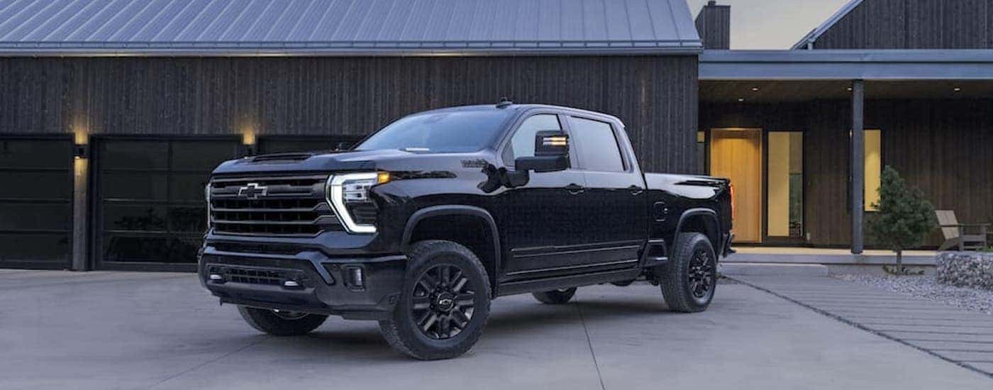 A black 2024 Chevy Silverado 2500 HD from the side.