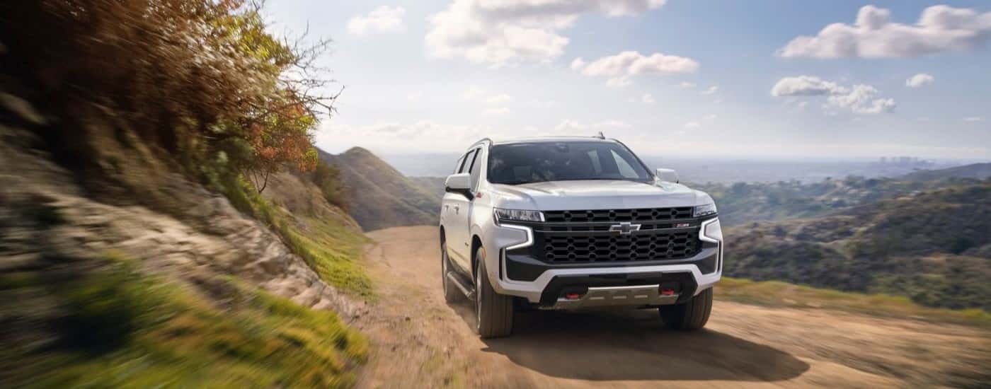 A white used 2021 Chevy Tahoe Z71 for sale near Harrisburg off-roading on a trail