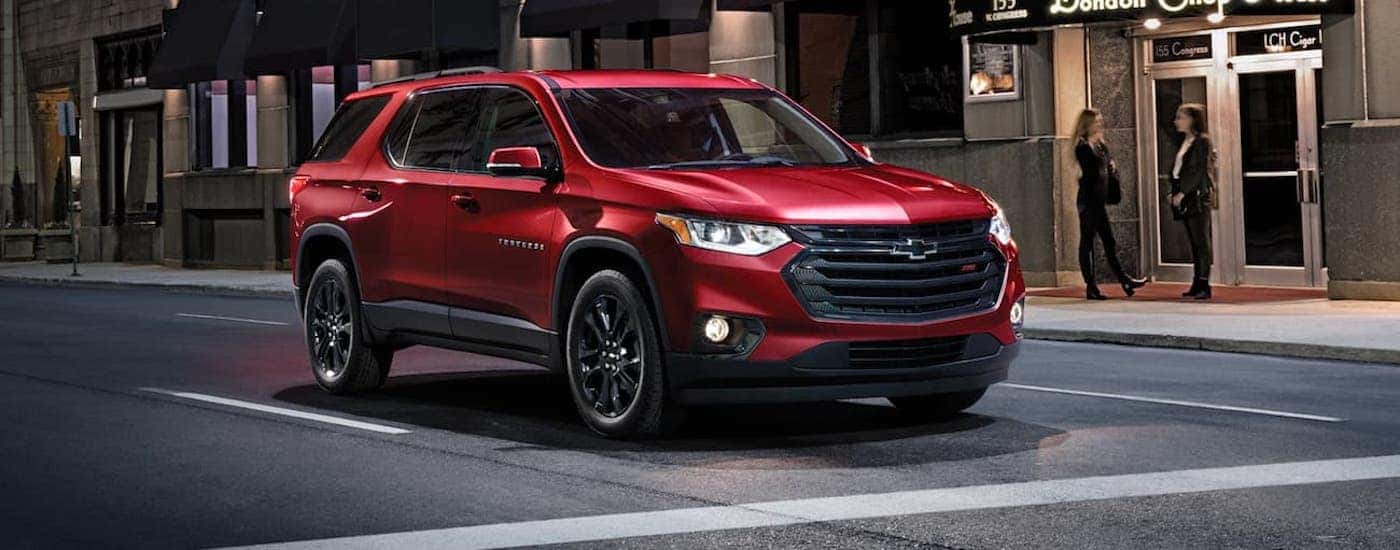 Red 2020 Chevy Traverse RS for sale near Belmont stopped at an intersection.