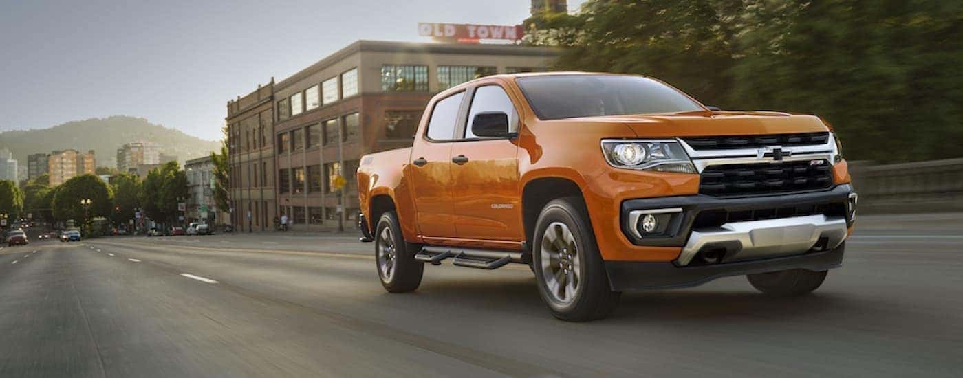Orange 2021 Chevy Colorado Z71 driving down an open road.