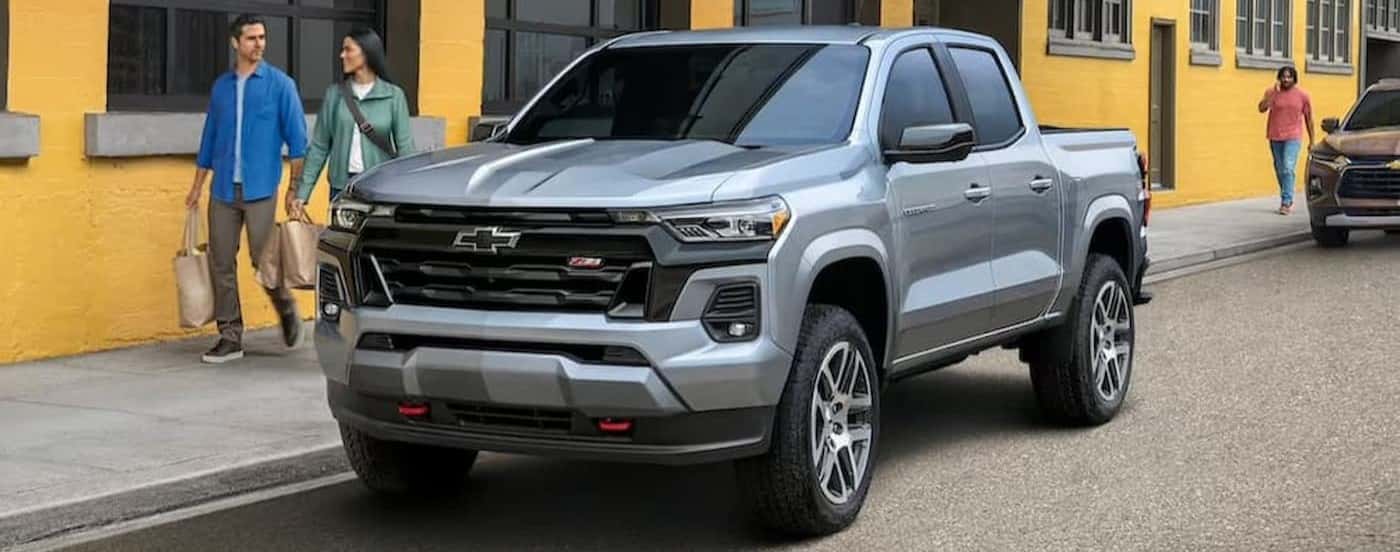 A silver 2023 Chevy Colorado Z71 parked in a city.