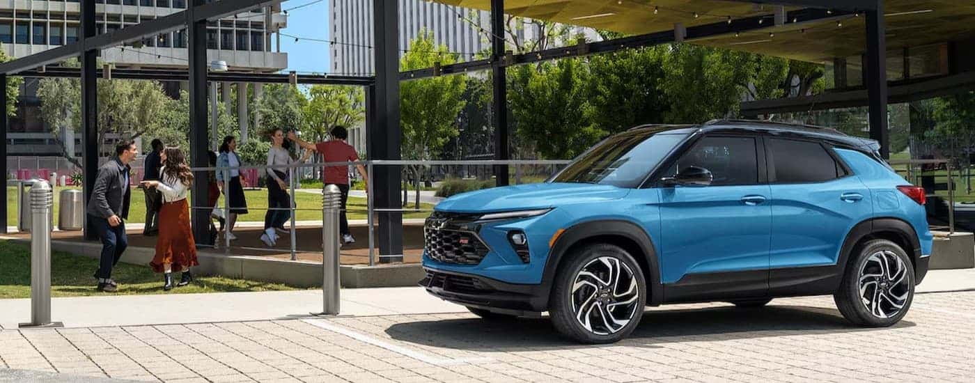 A blue 2024 Chevy Trailblazer RS parked near a school.