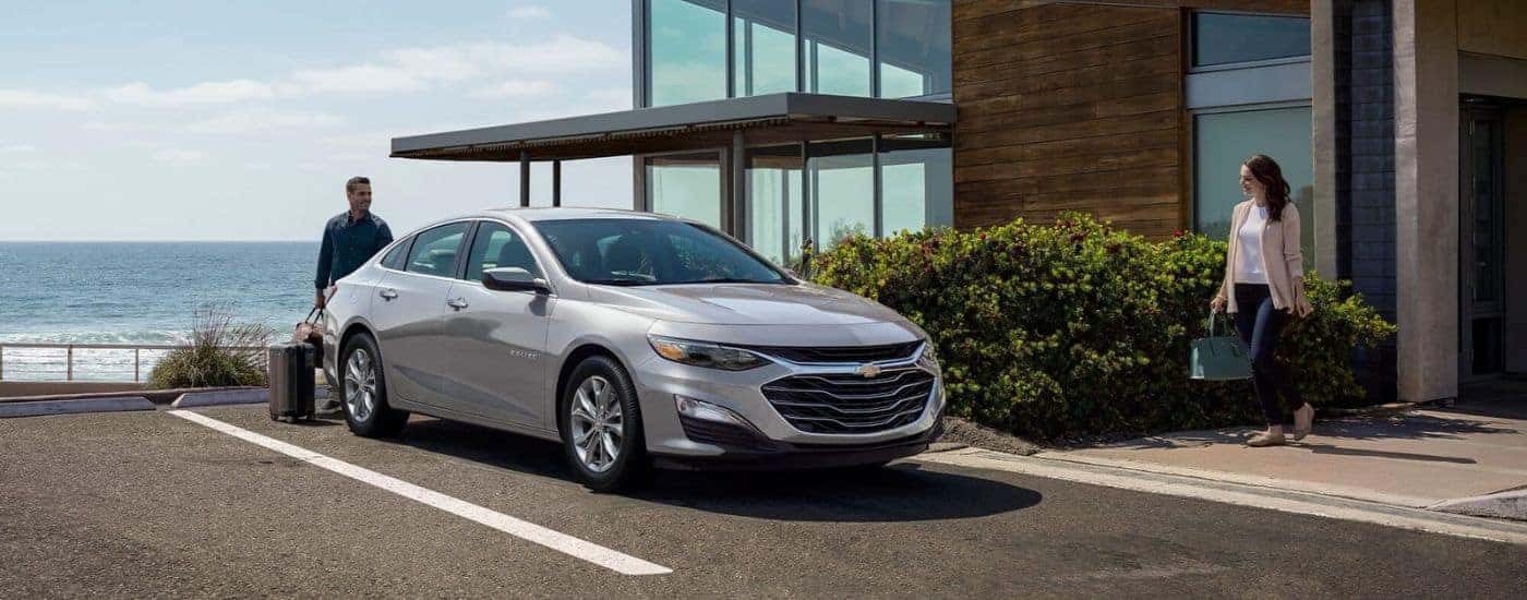 Silver 2024 Chevy Malibu parked in front of a house