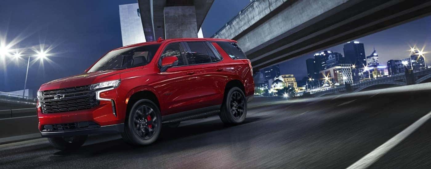 A red 2023 Chevy Tahoe from the front.