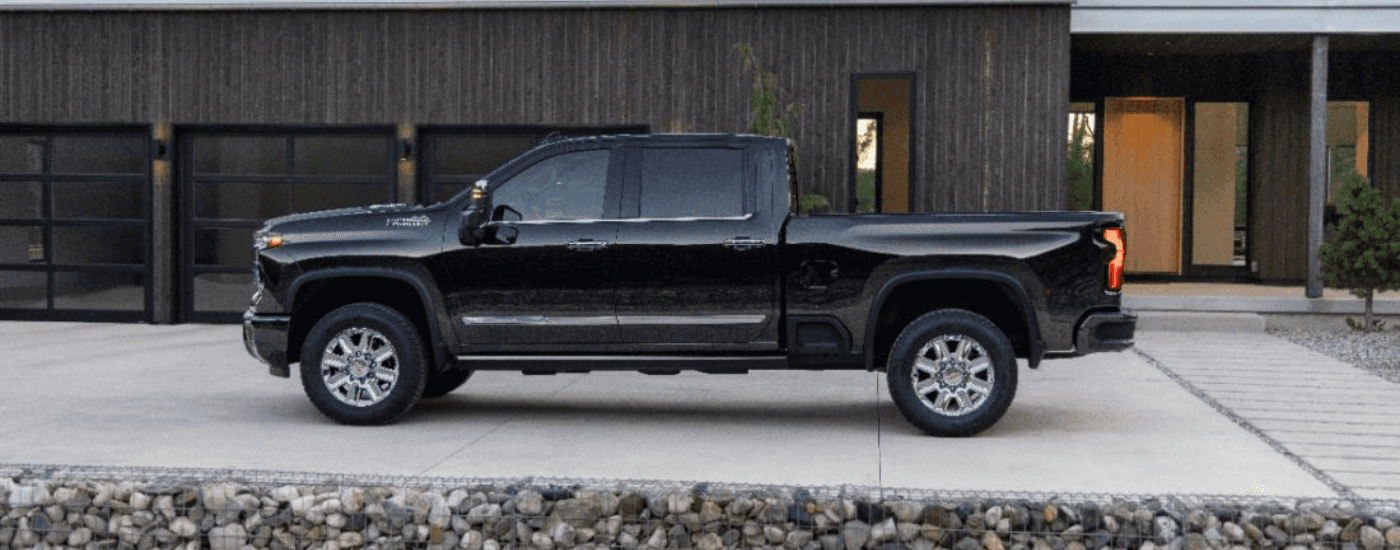 Black 2024 Chevy Silverado 2500 HD High Country parked in a driveway