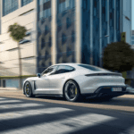 The 2021 Porsche Taycan driving through a city.