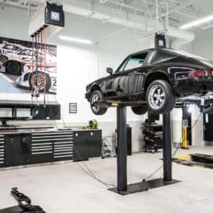 Older Porsche Model on lift in service bay