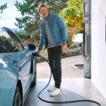 Man charging electric Porsche vehicle at home