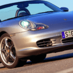 Silver Porsche Boxter 986 on road with blue skies in the background