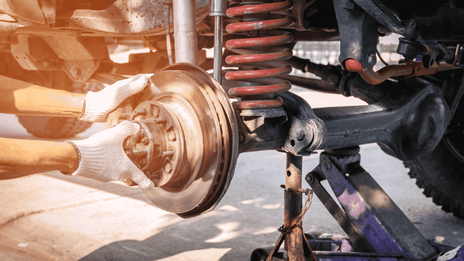 Mechanic working on car suspension system