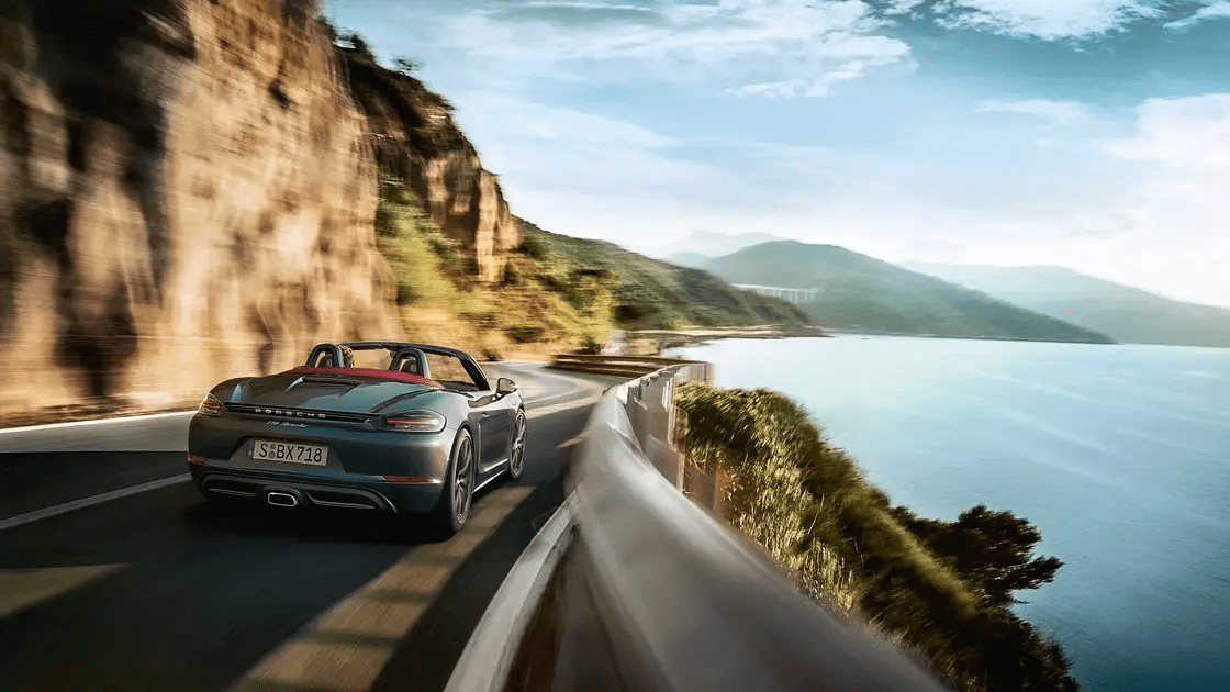 New Porsche driving on a highway