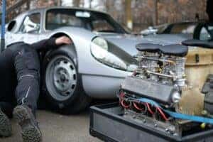 Technician working on a Porsche oil change and engine service