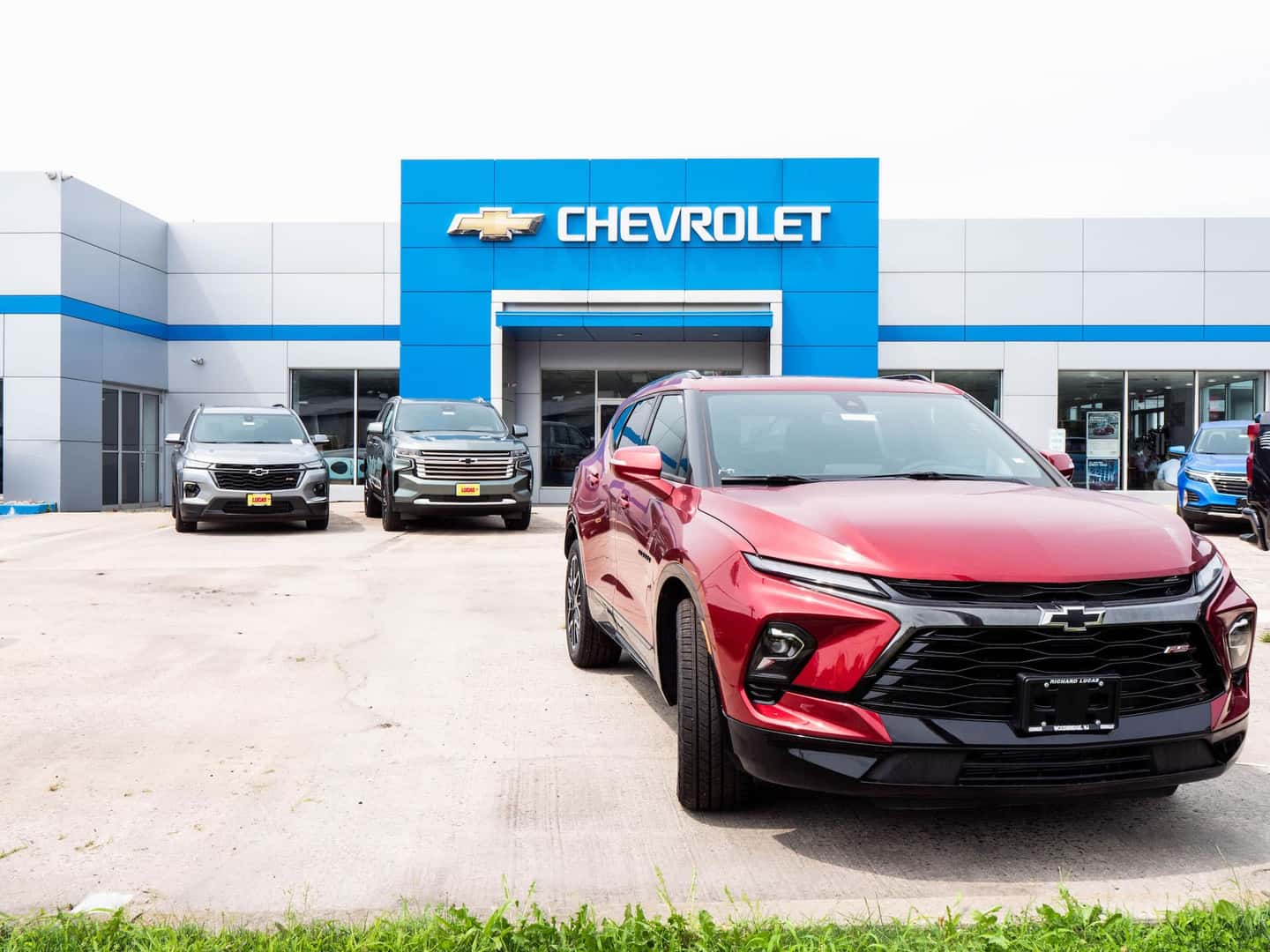 Red Chevy in front of dealership