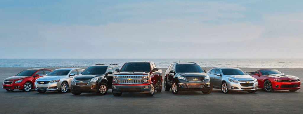 Seven different 2025 Chevy vehicles parked near the shoreline.