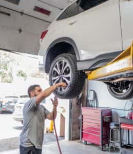 Mechanic adding air to the tires.