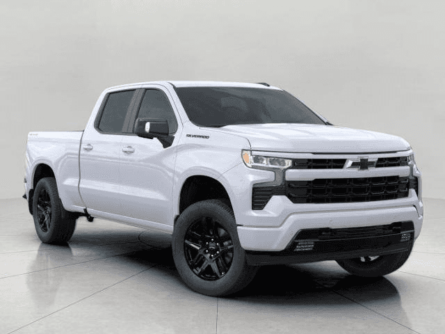 A clean, white Chevrolet Silverado pickup truck is shown from a front-quarter angle, parked indoors with a plain light-colored background. The truck has black wheels and a blacked-out grille, giving it a sporty and modern look. The 4x4 emblem is visible on the rear of the truck bed.