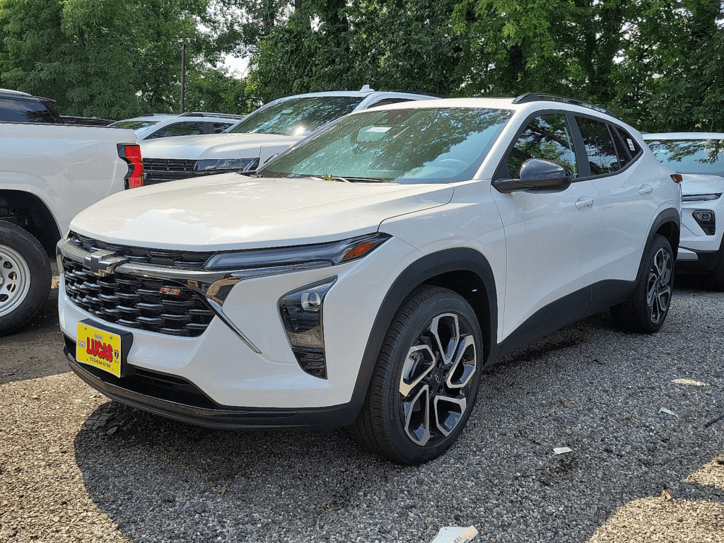2025 Chevy Trax in white with Lucas on the front plate parked in a dealership lot.