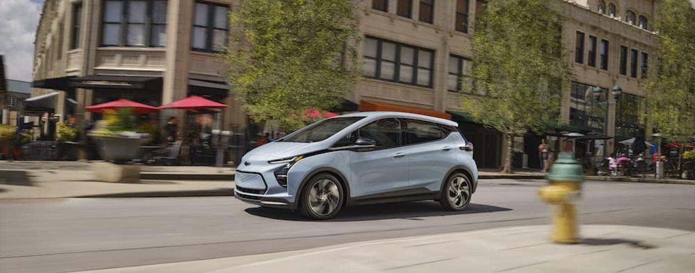 A Certified Pre-Owned Chevrolet, a blue 2023 Chevy Bolt EV is shown from the side.