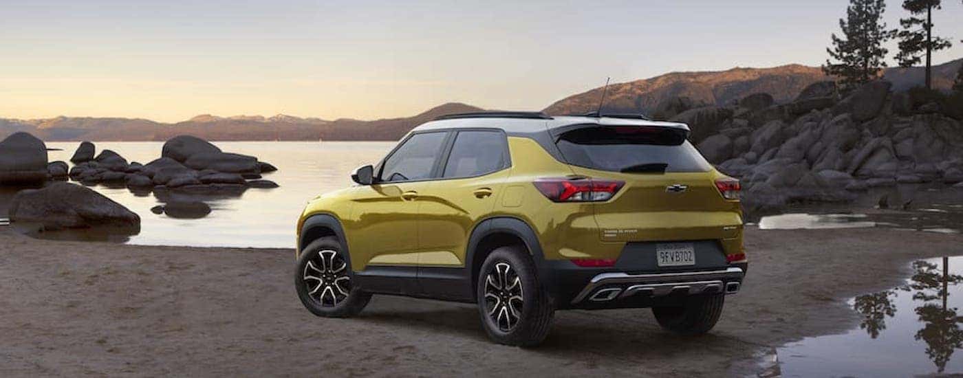 A yellow 2023 Chevy Trailblazer ACTIV is shown from the rear at an angle.