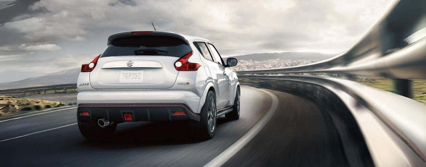 A white 2017 Certified Pre-Owned Nissan Juke Nismo is shown driving on a highway.