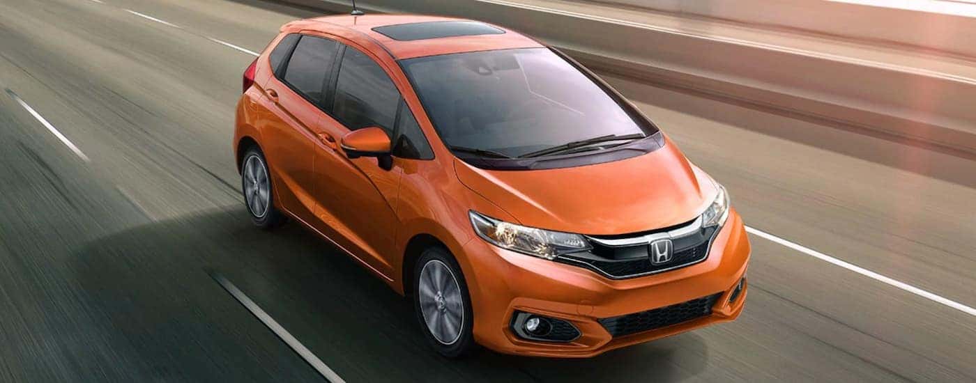 Overhead view of an orange 2020 Honda Fit EX-L driving on the highway.