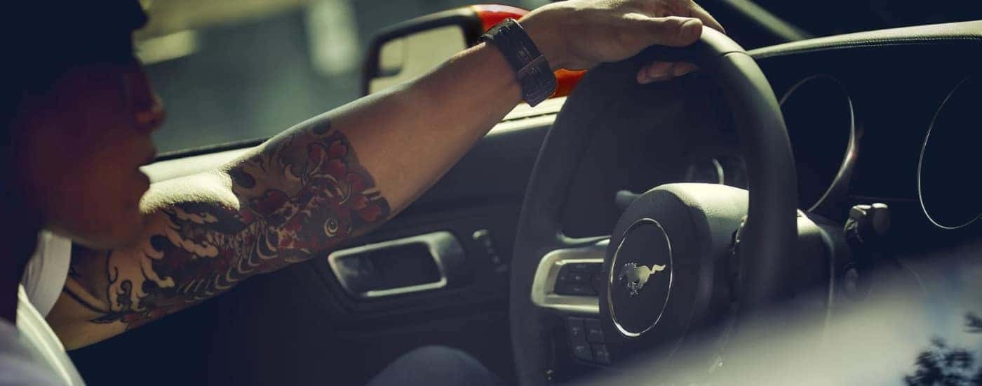 Person steering a 2022 Ford Mustang
