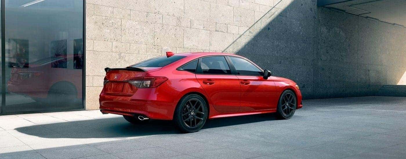 Red 2023 Honda Civic Si is shown parked near a building