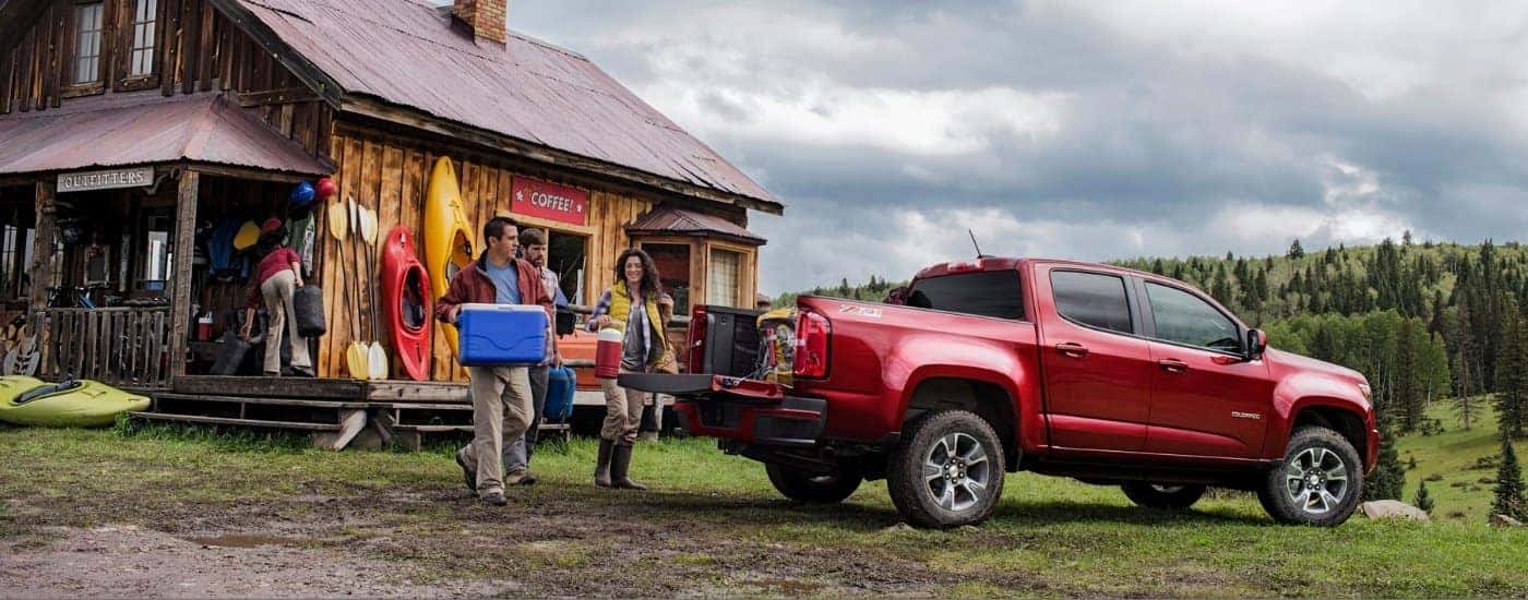 Red 2016 Chevy Colorado Z71 parked near a cabin
