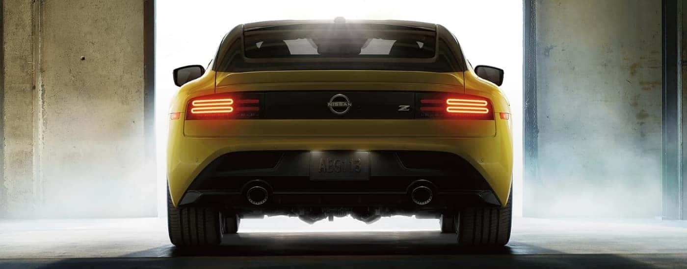 Yellow 2023 Nissan Z is shown in a garage from the rear
