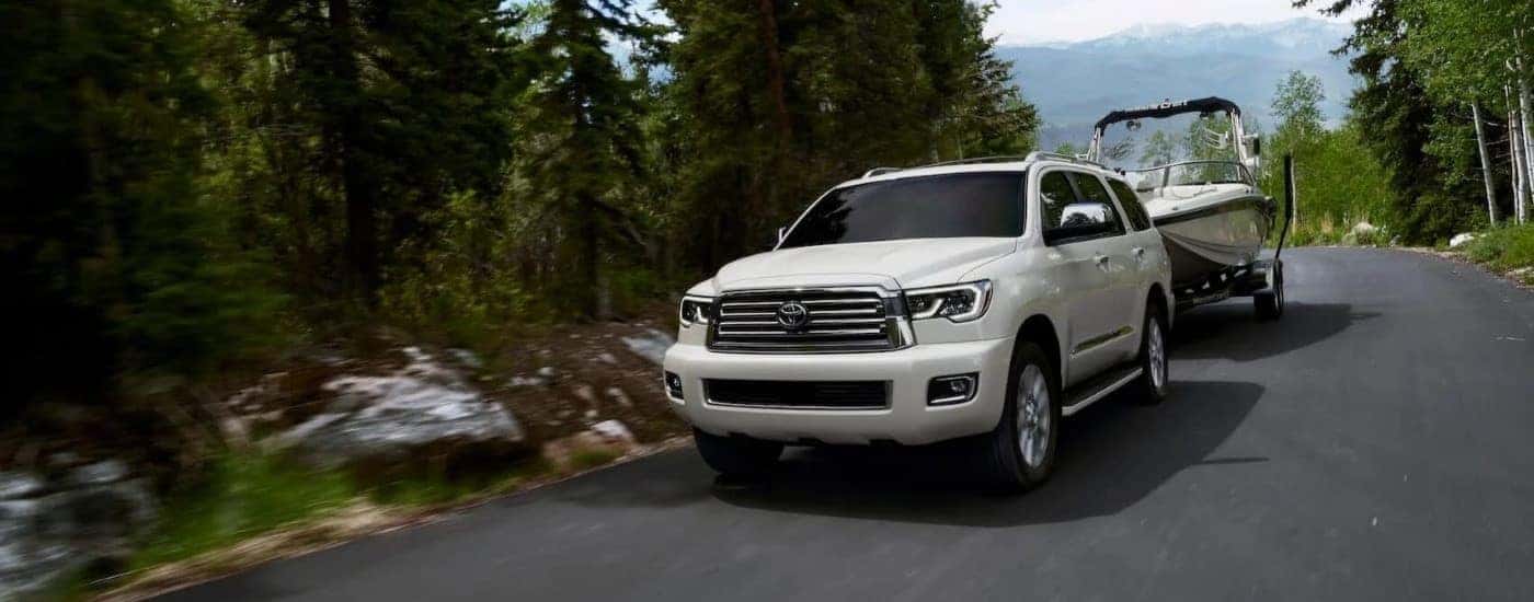 White 2020 Toyota Sequoia is shown towing a boat.
