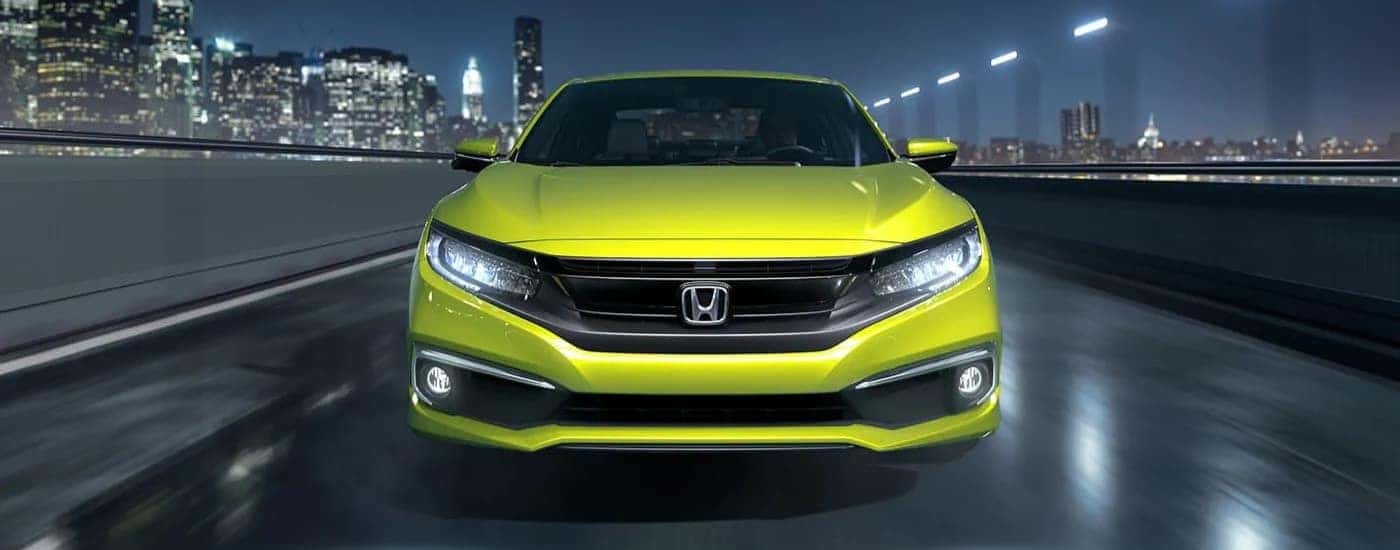 Neon Green 2019 Honda Civic Touring driving through a city