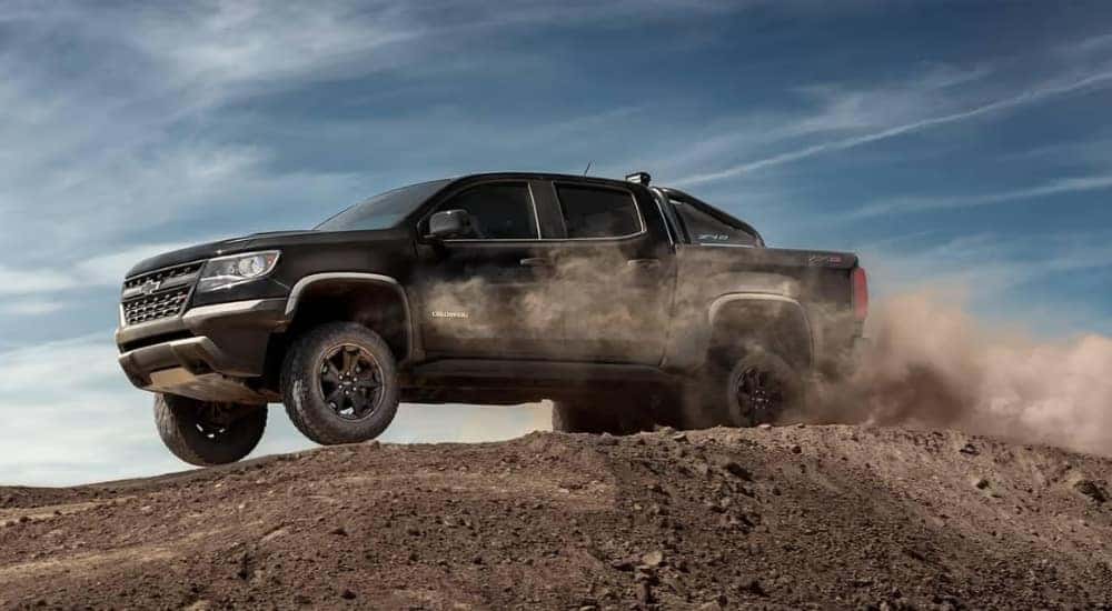 A black 2019 Chevy Colorado ZR2 is driving to look at Certified Pre-Owned trucks for sale.