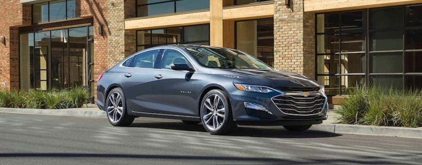 A grey 2019 Chevy Malibu is shown from the front at an angle after leaving a dealer that has used cars for sale near Springfield.