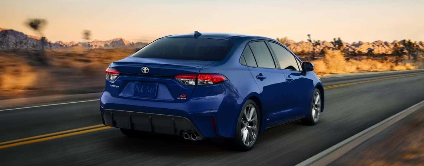 A blue 2025 Toyota Corolla SE is shown from the rear at an angle.