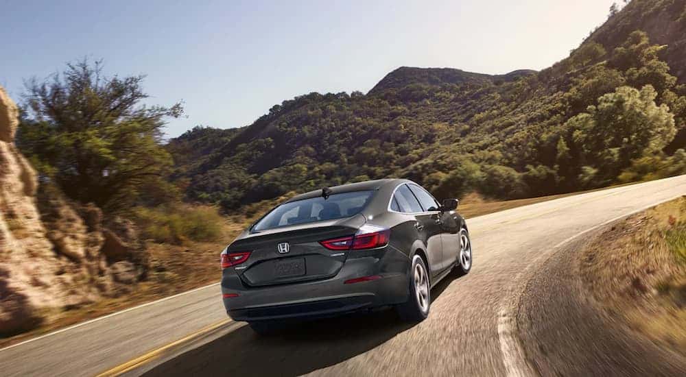 A gray 2022 Honda Insight driving to view used cars for sale near Norris.