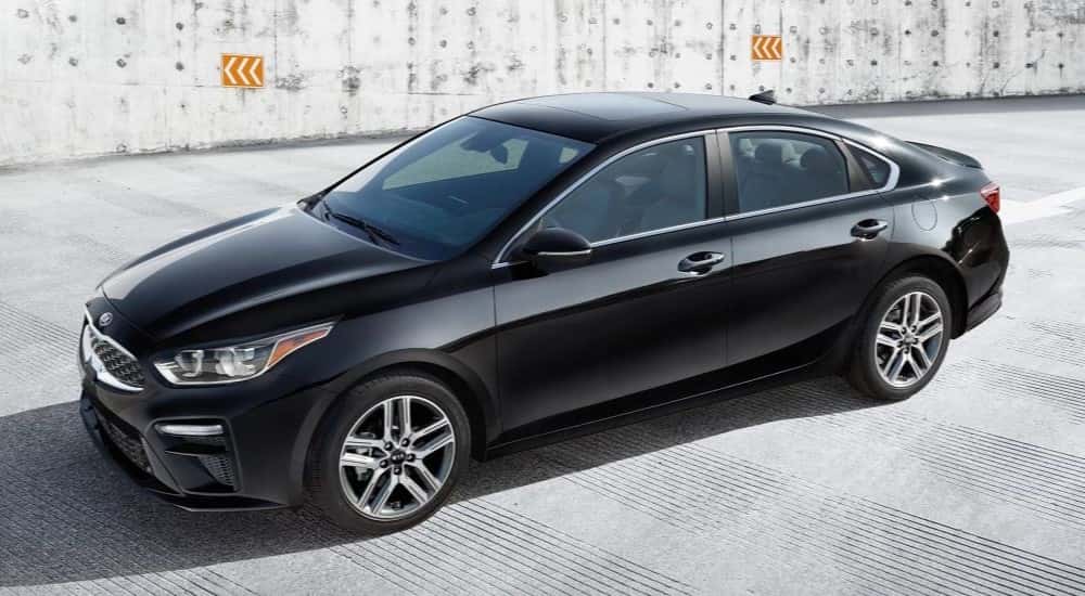A black 2022 Kia Forte parked on a sunny day.