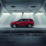 A red 2018 Chevy Equinox driving in a tunnel.