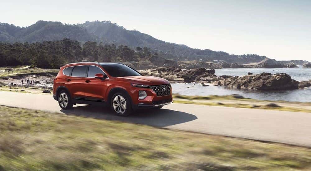 A red used 2019 Hyundai Santa driving down the road