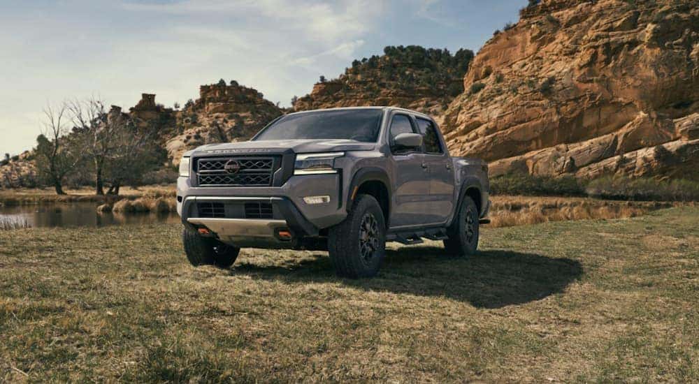 A silver 2022 Nissan Frontier parked on grass