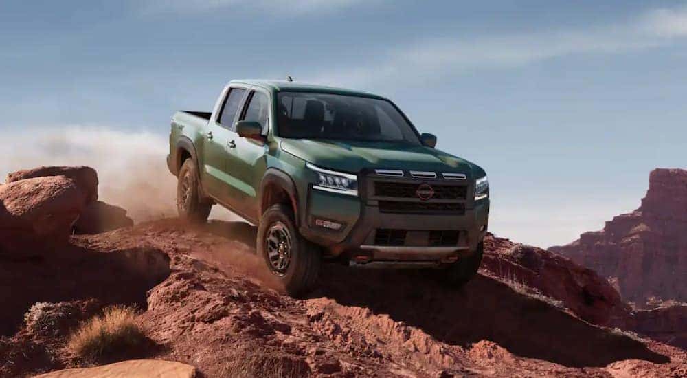 A green 2025 Nissan Frontier for sale off-roading