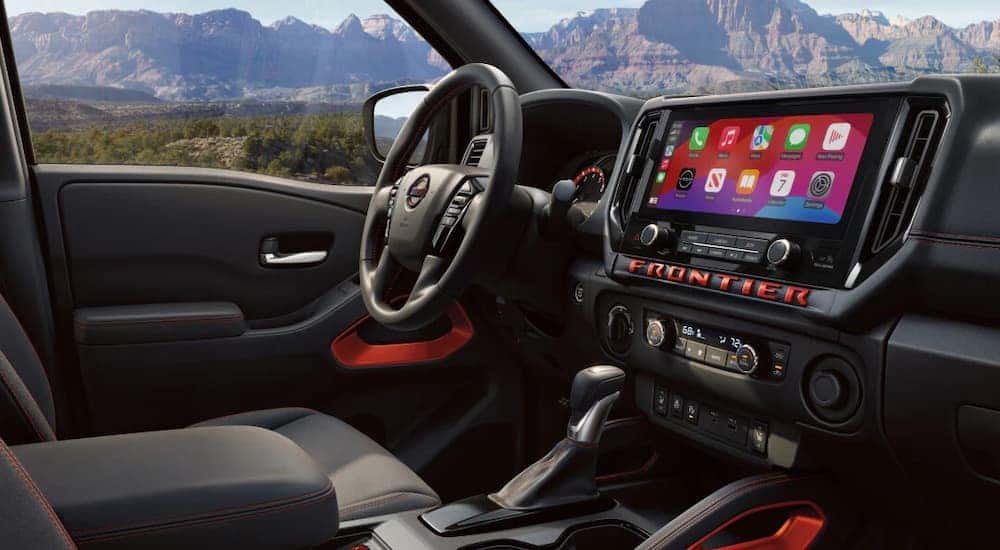 Infotainment and digital gauge cluster on a 2025 Nissan Frontier for sale