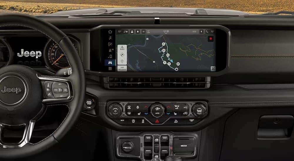 The black dash in a used 2025 Jeep Wrangler for sale.