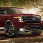 A red 2015 used Ford Explorer for sale in the woods.