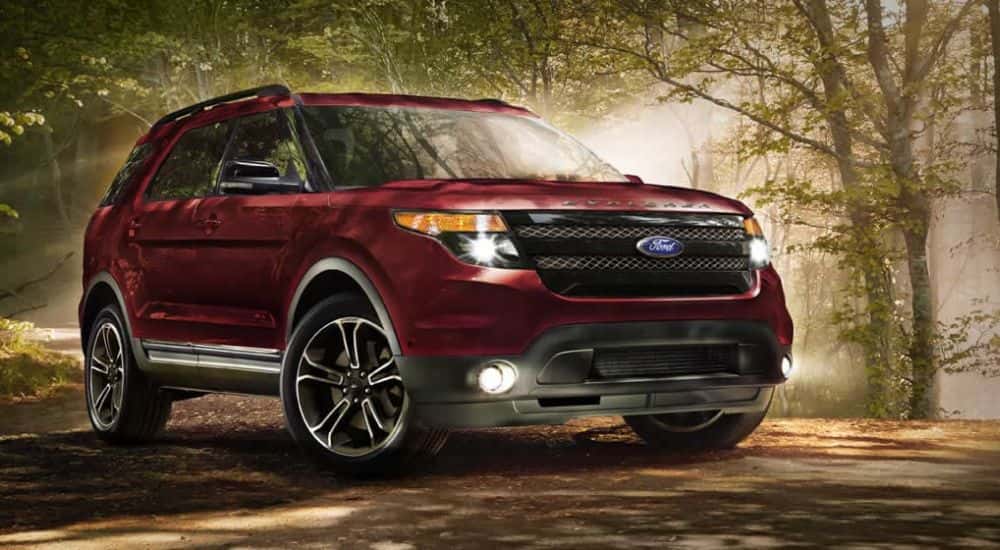 A red 2015 used Ford Explorer for sale in the woods.