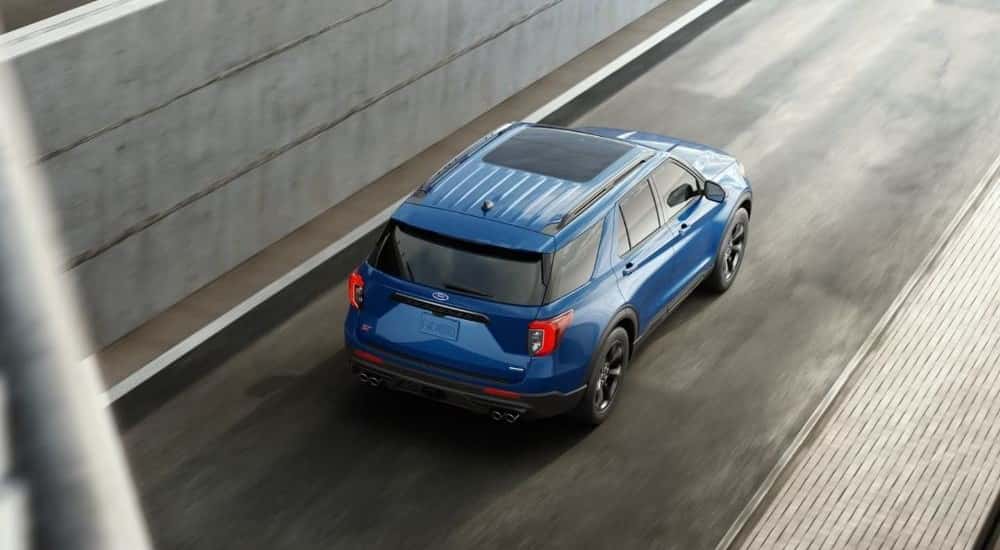 Aerial view of a blue 2022 Ford Explorer ST driving on a city street.