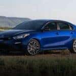 A blue 2020 Kia Forte parked on a sunny day.